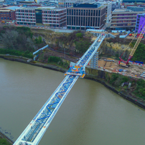 Picture of a steel bridge going across the water.