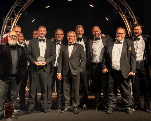 Men in suits on a stage.