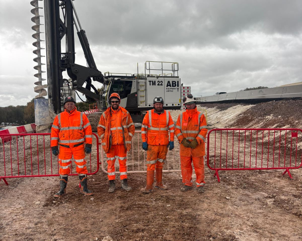 Group of men stood in front of an ABI TM22.