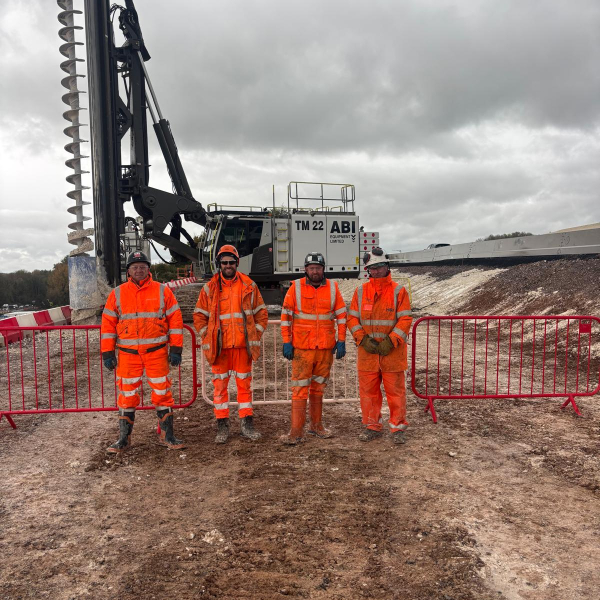 Group of men stood in front of an ABI TM22.